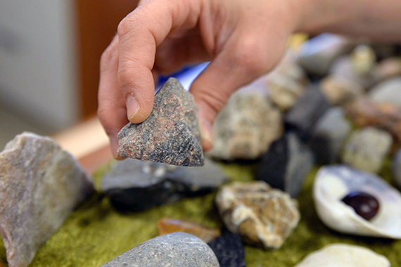 Picture of Resteghini's hand holding a piece of granite from Scotland.