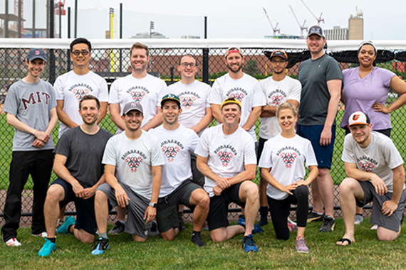 Photo of a softball team in white uniforms.